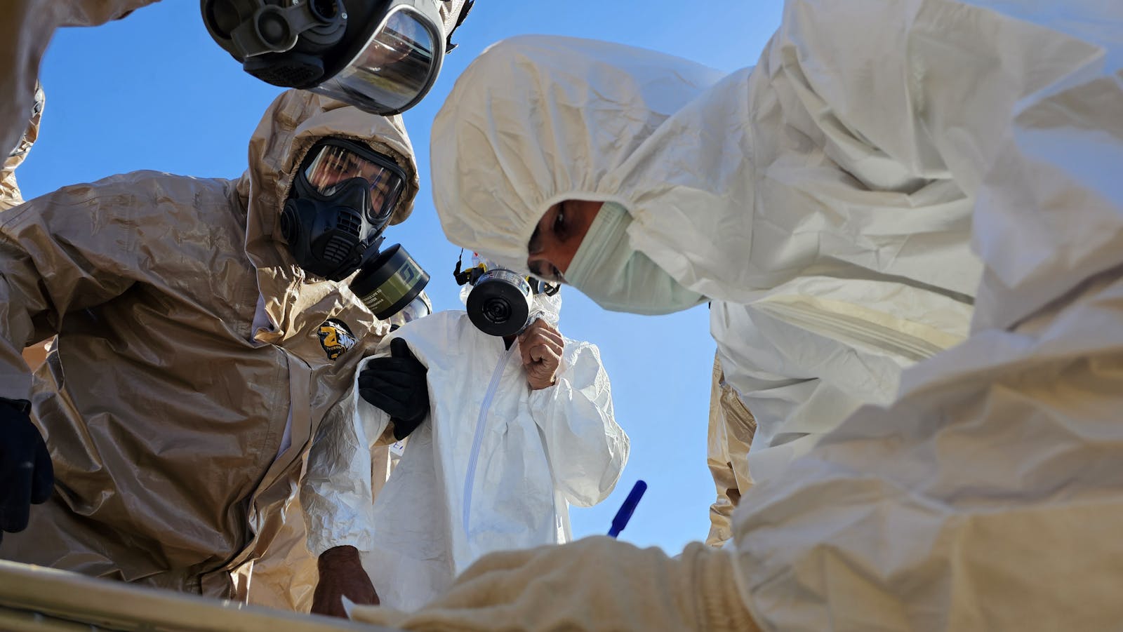 Protective technicians conducting a cleanup inspection
